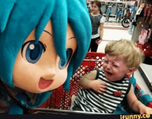 a little boy is crying next to a mascot in a shopping cart .