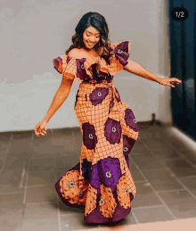 a woman in an orange and purple off the shoulder dress dancing