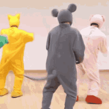 a group of people are standing next to each other in animal costumes .