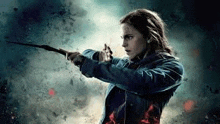 a woman in a blue jacket is holding a wand .