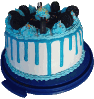 a cake with blue frosting and oreos on top of it