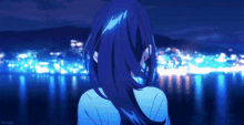 a girl with blue hair is looking at a city at night .