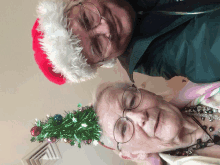 a man and an elderly woman wearing santa hats