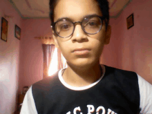 a boy wearing glasses and a shirt that says c.p.o.