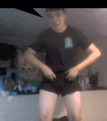 a blurry picture of a man in shorts and a black shirt