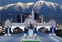 a statue of a man riding a horse is in front of a city skyline