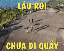 an aerial view of a group of people playing soccer with the words lau roi chua di quay in yellow letters