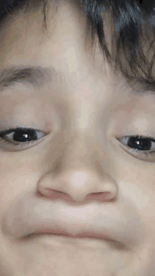 a close up of a child 's face making a face