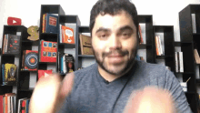 a man is standing in front of a bookshelf with a book titled " quentin tarantino " on the shelf