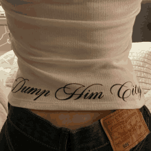 a person wearing a tank top that says dump him city on it