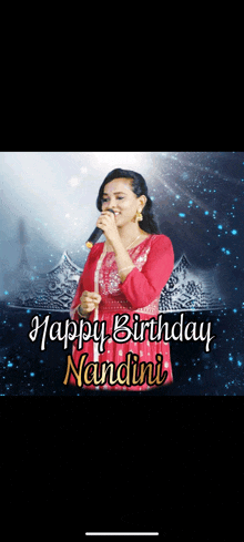 a woman singing into a microphone with the words " happy birthday nandini " behind her