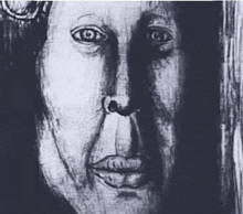 a black and white drawing of a man 's face with a shadow on the wall .