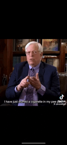 a man in a suit and tie is talking about stuffing a cigarette in his pee