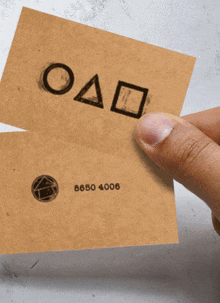 a person is holding a card that says oad and 8650 4006