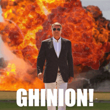 a man in a suit is standing in front of an explosion and the word ghinion is on the bottom