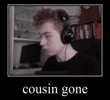 a young man wearing headphones is sitting in front of a computer and a bookshelf .