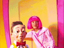 a girl with pink hair stands next to a boy with a bow tie