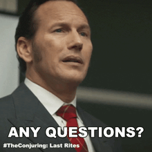 a man in a suit and tie with the words any questions below him