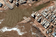 an aerial view of a flooded area with buildings and water