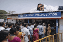 a man laying on top of an election office polling station sign