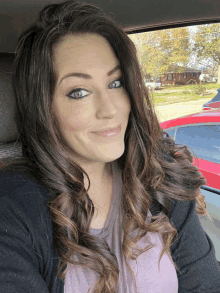 a woman sitting in a car with her eyes closed