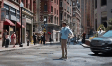 a man stands in the middle of a city street in front of a sign that says ' comfort ' on it