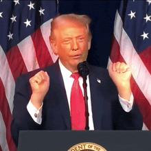 a man in a suit and tie stands at a podium that says dent of the united states