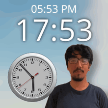 a man standing in front of a clock that says 17:53 pm