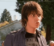 a young man wearing a t-shirt that says rock on it
