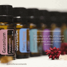 a bottle of geranium essential oil sits next to other bottles of essential oil