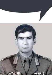 a black and white photo of a man in a military uniform with a speech bubble above his head .