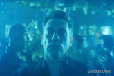 a man is dancing in a club with a gif run.com watermark