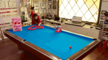 a pool table in a room with a sign that says you are the one