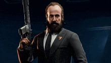 a man with a beard is holding a gun in a suit and tie .