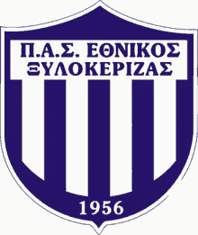 a blue and white emblem with the year 1956 on it