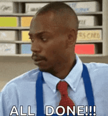 a man in a blue shirt and red tie is making a funny face and saying `` all done '' .