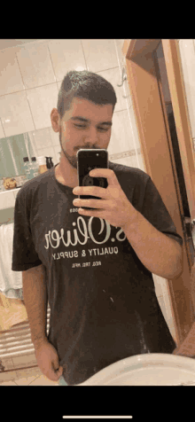 a man taking a picture of himself in a mirror with a shirt that says " soul "