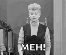 a black and white photo of a woman making a funny face and saying `` meh '' .