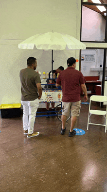 a man standing in front of a cart that says ice cream