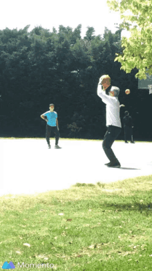 a man throws a basketball at another man on a basketball court with the word momento on the bottom