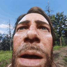 a man with a beard and a bandage on his head looks at the camera