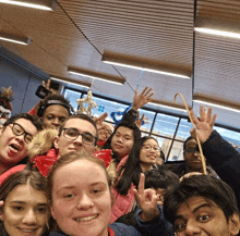 a group of people are posing for a picture and one of them is wearing glasses