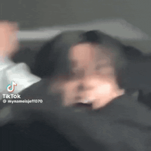 a blurry picture of a person 's face with a tiktok watermark on the bottom