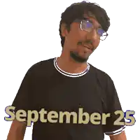 a man wearing glasses and a black shirt with the date september 25