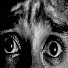 a close up of a person 's eyes with a tiger 's face in the background .