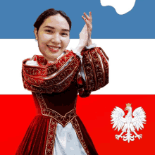 a woman in a red and white dress stands in front of a flag