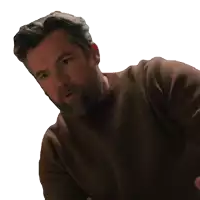 a man with a beard in a brown sweater is holding a jar