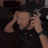 a man wearing headphones and a black shirt that says y on it
