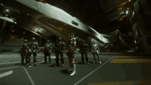 a group of soldiers are standing in front of a large ship that says a on it