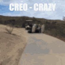 a blurry picture of a dirt road with the words creo- crazy written above it